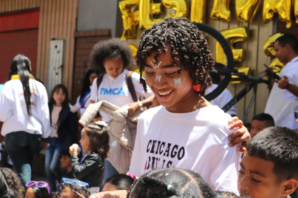 Children and community members celebrating at the "Distintos somos todos" festival in Colombia, organized by Children Change Colombia to promote inclusion and prevent sexual and gender-based violence.